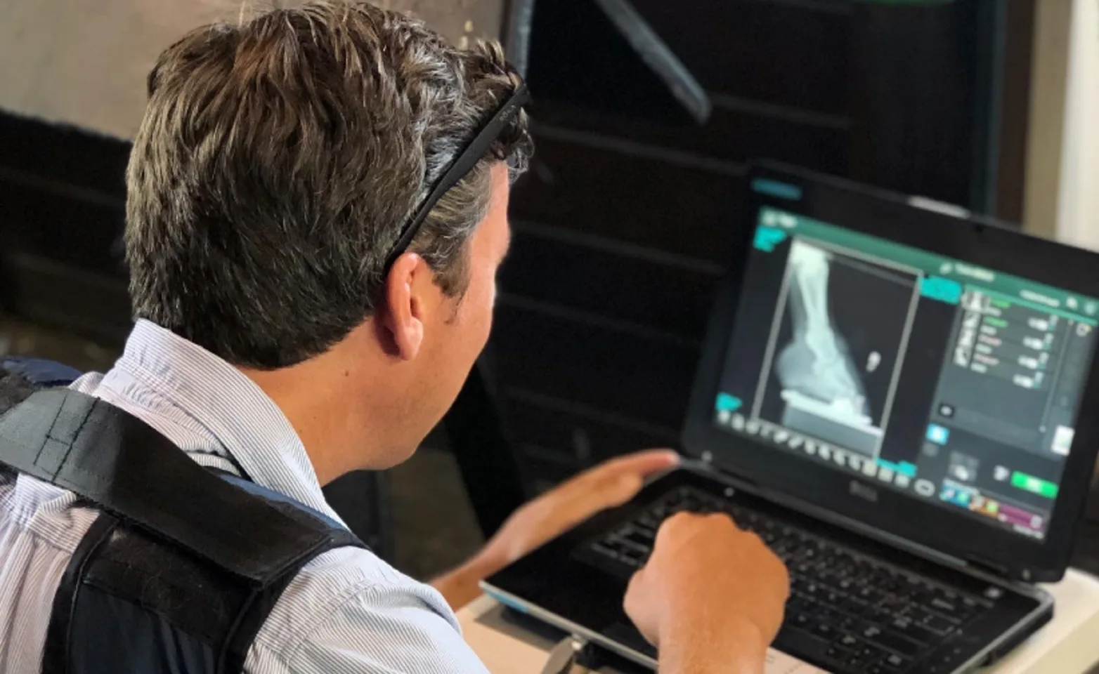 Dr. Isaiah Robinson views hoof radiographs on a laptop